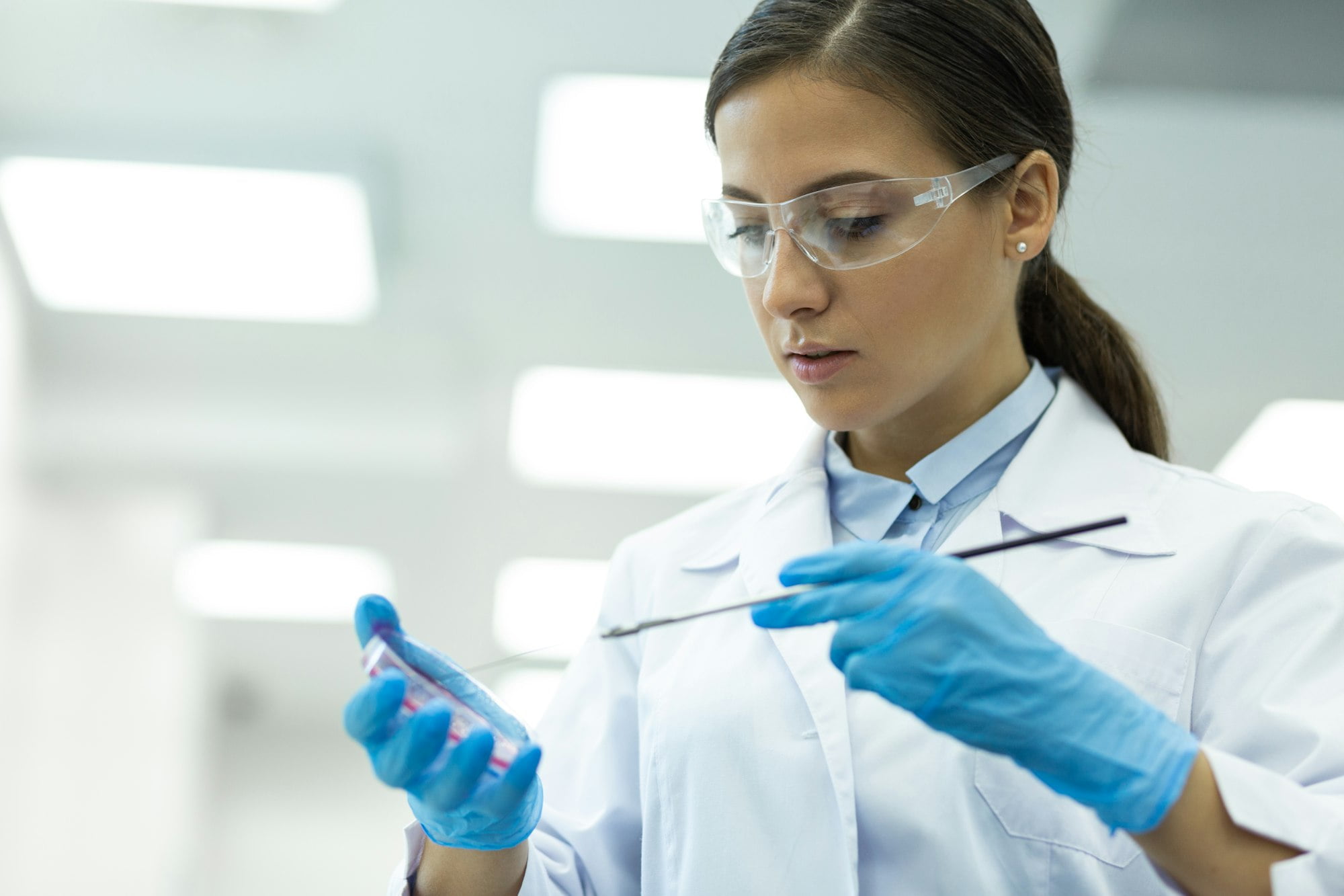 Close up of young medical worker that doing experiment