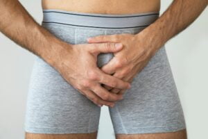 Young man suffering from penile pain